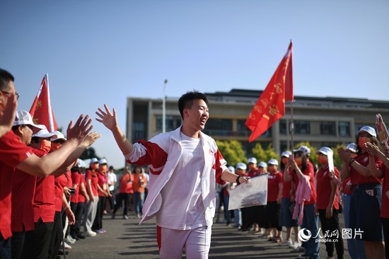 6月7日，在北京市人大附中通州校區(qū)考點，考生與送考老師擊掌加油。人民網(wǎng)記者 翁奇羽攝