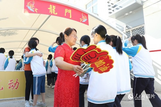 6月7日一早，雄安新區(qū)安新中學老師在給同學們加油鼓勁兒。人民網(wǎng) 李兆民攝