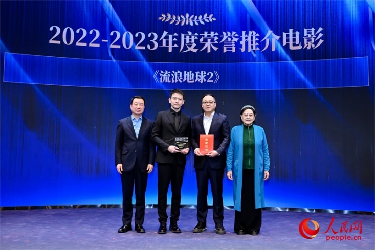 著名電影藝術(shù)家、事業(yè)家王曉棠（右一）和中國文聯(lián)書記處書記張宏（左一）為《流浪地球2》出品人、總監(jiān)制、總制片人傅若清（右二）與導(dǎo)演郭帆（左二）頒發(fā)“2022-2023年度榮譽推介電影”