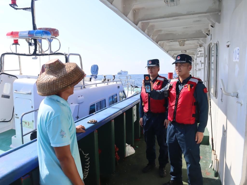 圖為5月12日海警執(zhí)法員登臨檢查漁船。（中國(guó)海警局南海分局供圖）