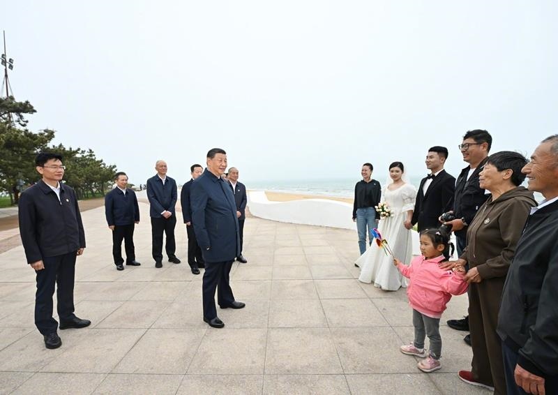 5月22日，在山東日照考察調(diào)研的習近平總書記來到陽光海岸綠道，同市民游客親切交流。